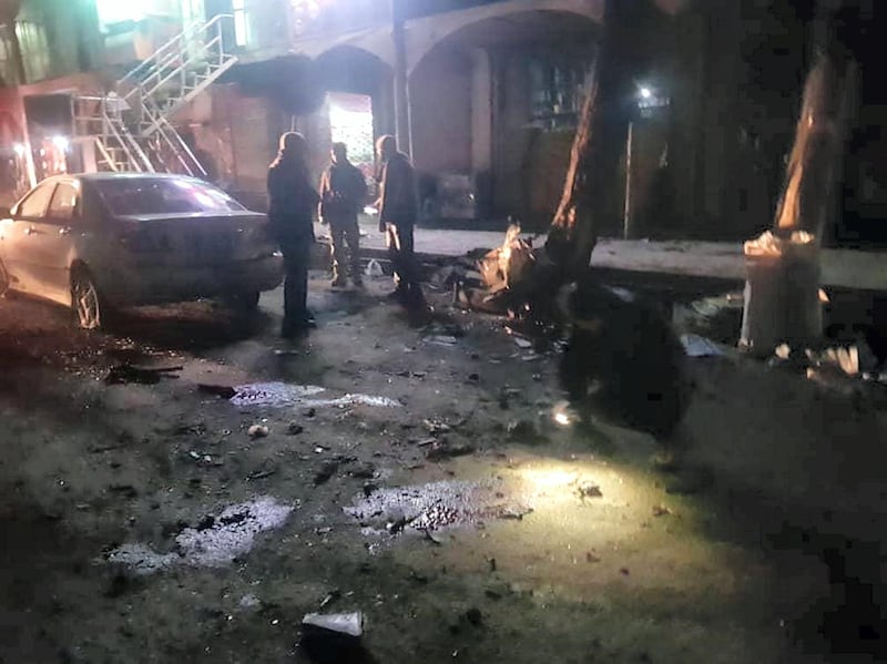  Investigators and passers-by inspect the damage after two bombs ripped though Bamyan city in Afghanistan. Courtesy Mohammad Reza Yousefi.