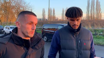 Aston Villa's John McGinn and Tyrone Mings on Wednesday visit near the scene in Babbs Mill Park in Kingshurst, Solihull, after the deaths of the boys. PA