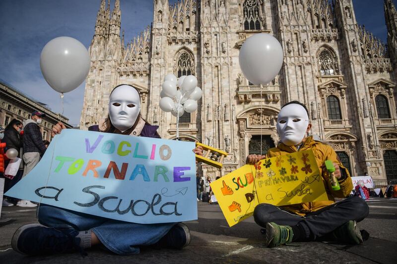 People take part in a demonstration against distance learning organised by the National Network 'School in Presence' in Duomo square, Milan, Italy. Schools and kindergartens in Milan and the entire Lombardy region are closed as the area is in the coronavirus red zone. EPA