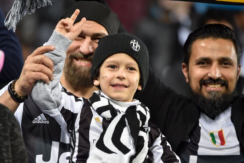 Juventus supporters cheer during the Supercoppa Italiana final. AFP