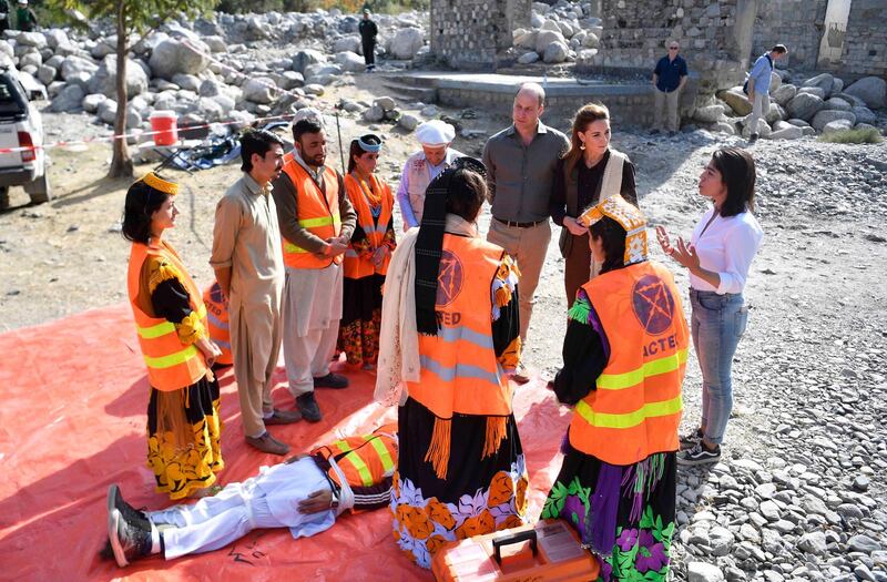 Britain's William and Catherine (C), Duke and Duchess of Cambridge speak to emergency response team in the village of Bumburet in the Chitral District of Khyber-Pakhunkwa Province in Pakistan.  EPA