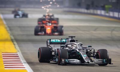 SINGAPORE, SINGAPORE - SEPTEMBER 22: Lewis Hamilton of Great Britain driving the (44) Mercedes AMG Petronas F1 Team Mercedes W10 leads Sebastian Vettel of Germany driving the (5) Scuderia Ferrari SF90 on track during the F1 Grand Prix of Singapore at Marina Bay Street Circuit on September 22, 2019 in Singapore. (Photo by Lars Baron/Getty Images)