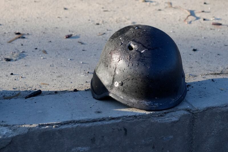 A soldier's helmet with a bullet hole on a street in the Ukrainian capital. AP