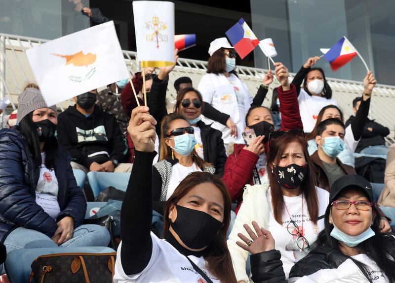 Worshippers wave flags at a football stadium in Nicosia, Cyprus, ahead of a mass celebrated by Pope Francis. The pontiff will head to Greece after he wraps up his visit to the island. EPA / KATIA CHRISTODOULOU