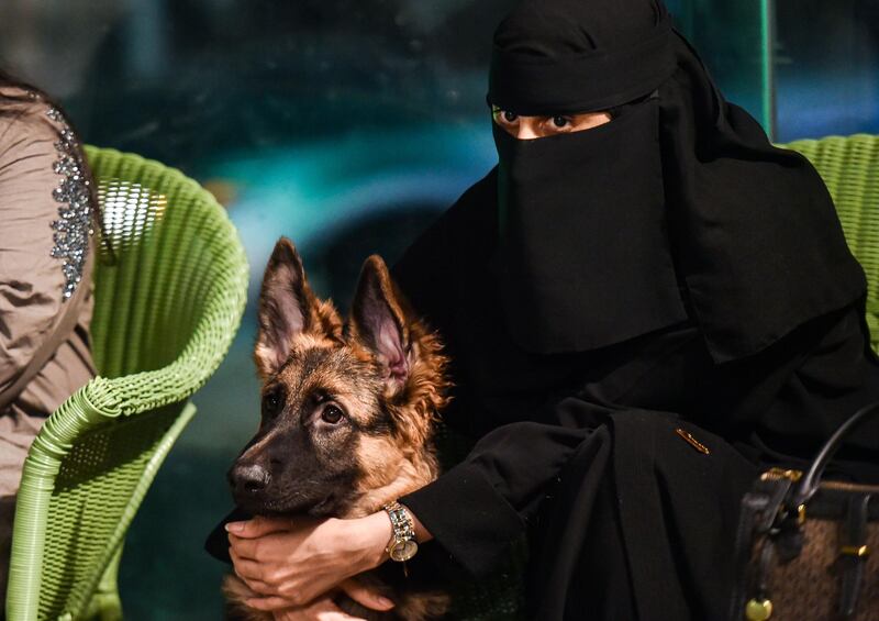 A woman sits with her German shepherd at the Barking Lot cafe in Saudi Arabia's eastern Gulf city of Khobar, 450 kilometres east of the capital, Riyadh. AFP