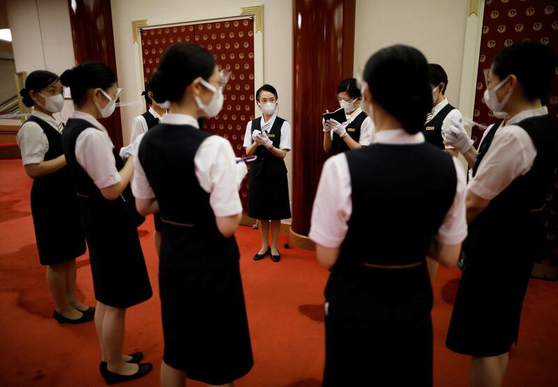 Staff members wearing protective face masks and shields hold a meeting at the Kabukiza Theatre, where Japan's stately traditional Kabuki theatre will resume on August 1 following a five-month closure due to the coronavirus disease (COVID-19) outbreak, in Tokyo, Japan July 31, 2020. Picture taken July 31, 2020. REUTERS/Issei Kato