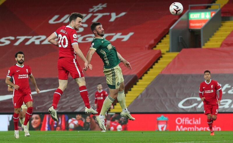 Liverpool's Diogo Jota, left heads home against Sheffield United. AP