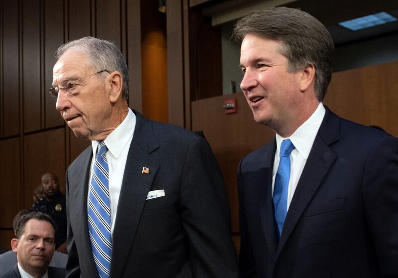 (FILES) In this file photo taken on September 5, 2018 US Supreme Court nominee Brett Kavanaugh (L), alongside US Senator Chuck Grassley, Chairman Judiciary Committee, arrives for the second day of his confirmation hearing in front of the US Senate on Capitol Hill in Washington DC. US President Donald Trump has stood firmly by his Supreme Court pick Brett Kavanaugh after allegations that the conservative judge sexually assaulted a woman when they were teenagers threatened to derail the nomination process. / AFP / SAUL LOEB
