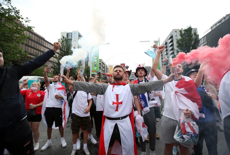 England fans with flares gather outside Wembley stadium ahead of the Euro 2020 final against Italy.