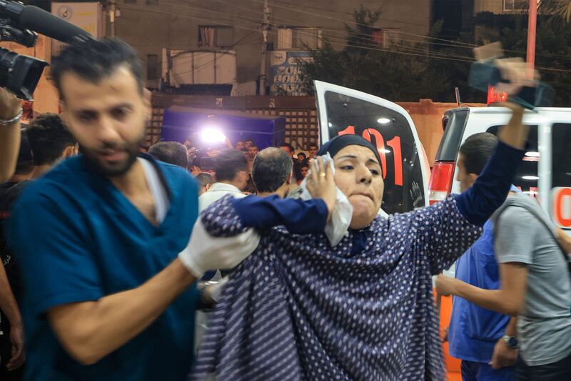 A wounded Palestinian woman is taken for treatment. AFP