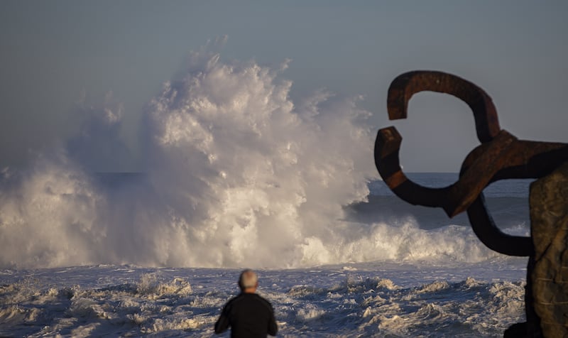 A man watches the waves in the early morning next to Eduardo Chillida's El Peine del Viento sculpture in San Sebastian, Spain. EPA