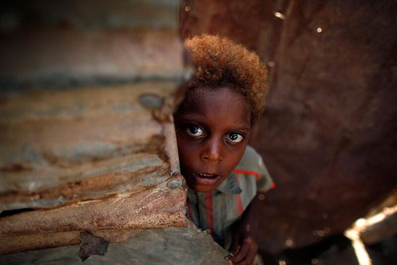 A boy stands at the door of his family's hut in Yemen's western port city of Houdieda.