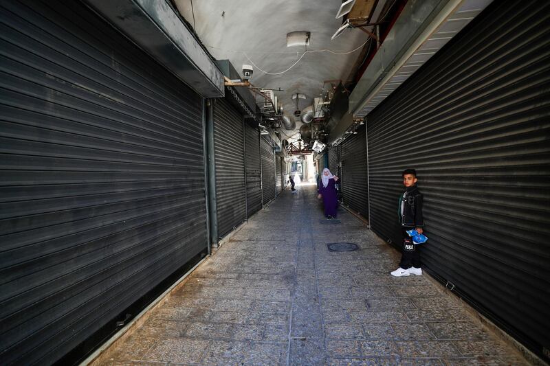 Palestinians walk in empty alley of Jerusalem old city during a general strike in the city. EPA