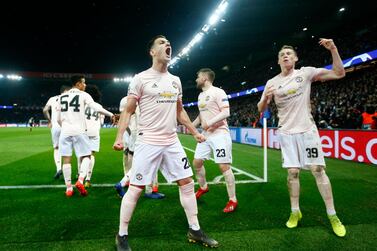 Manchester's Diogo Dalot, left, and Scott McTominay, right celebrate after their win in the Champions League round of 16 second leg match against PSG at the Parc des Princes Stadium in Paris on March 6, 2019. EPA