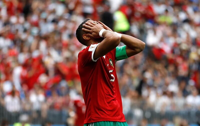 Morocco's Mehdi Benatia covers his faces after missing a chance to score. Francisco Seco / AP Photo