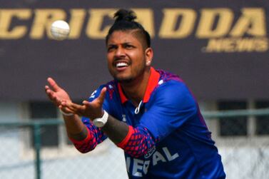 Nepal's cricketer Sandeep Lamichhane catches a ball during the ICC Men's Cricket World Cup League 2 match between Nepal and Scotland at the Tribhuvan University International Cricket Ground in Kathmandu on February 21, 2023.  (Photo by PRAKASH MATHEMA  /  AFP)