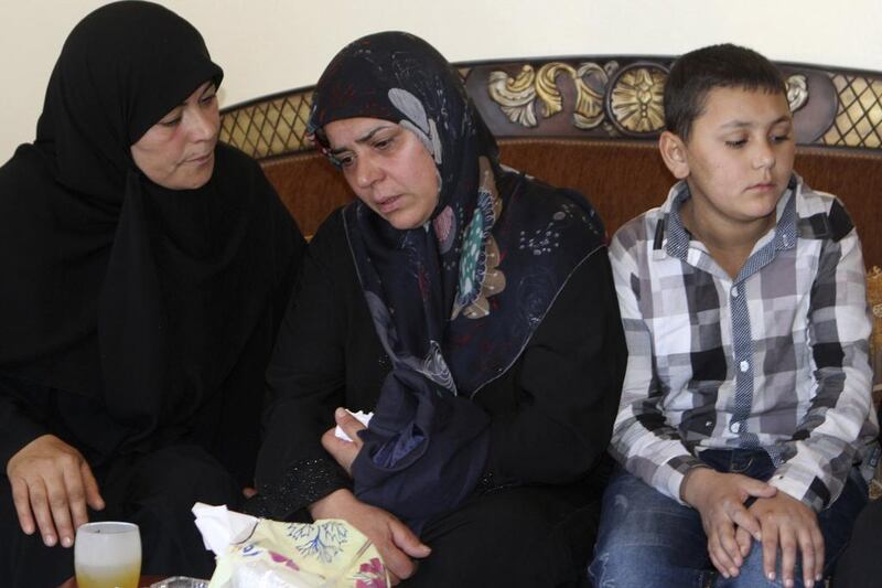 The mother, centre, of Lebanese soldier Abbas Medlej, who was beheaded by Islamic State of Iraq and the Levant militants in Arsal, mourns during his funeral in his hometown in Ansar, south Baalbak, on Sunday. Ahmad Shalha / Reuters