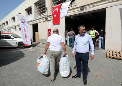 Collecting humanitarian aid in Al Quoz, Dubai. Volunteers are working around the clock to organise, pack and ship public donations. Chris Whiteoak / The National