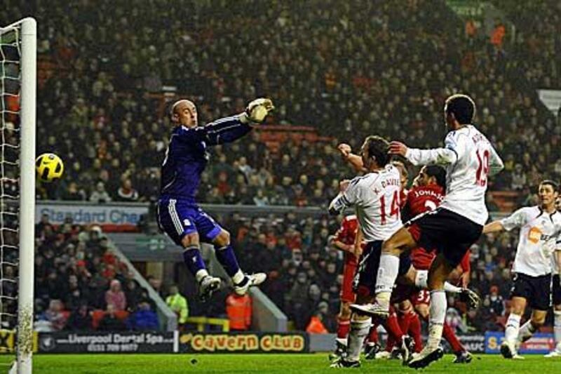 Bolton Wanderers' Kevin Davies, second from left, scores the opening goal past Liverpool's Spanish goalkeeper Pepe Reina.