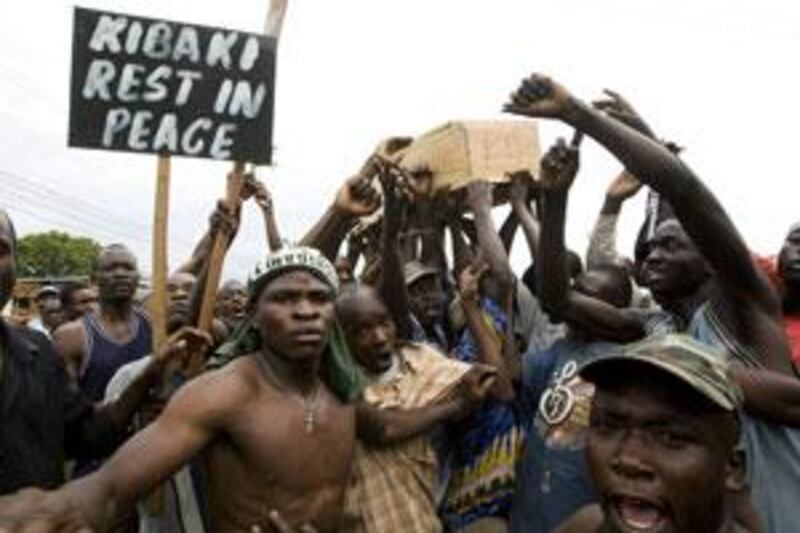 Supporters of Kenya's opposition leader, and prime minister, Raila Odinga carry out a mock burial ceremony of the Kenyan president Mwai Kibaki during a demonstration in Kisumu in January 2008. Election-related violence was blamed for 1,300 deaths, which some fear could happen again.