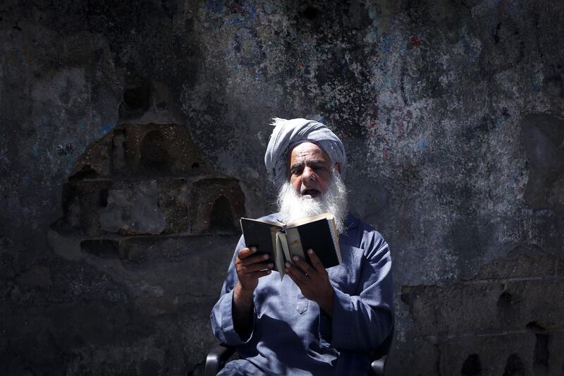 A Palestinian man reads the Koran during the holy month of Ramadan in Gaza City during the COVID-19 coronavirus pandemic.  AFP