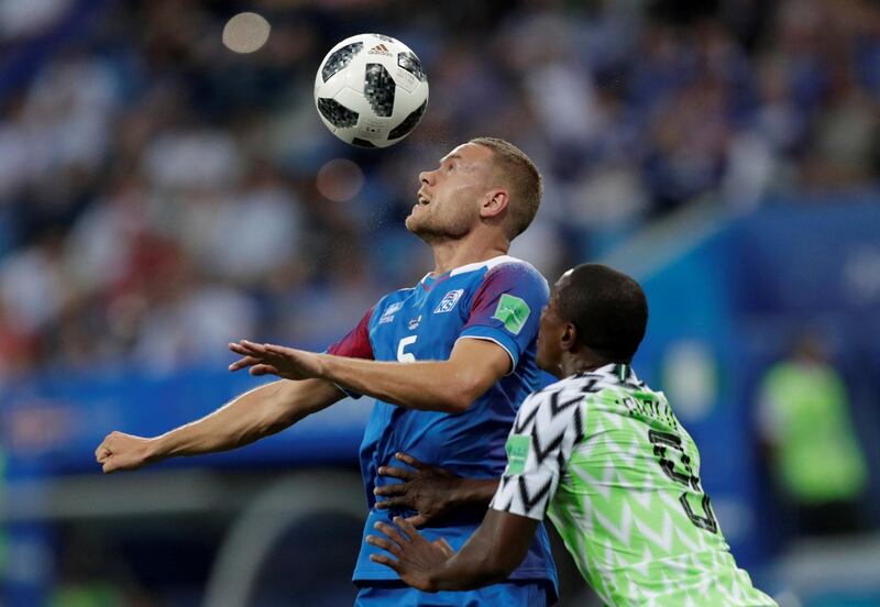 Sverrir Ingi Ingason wins a head in front of Nigeria's Odion Ighalo. Ueslei Marcelino / Reuters