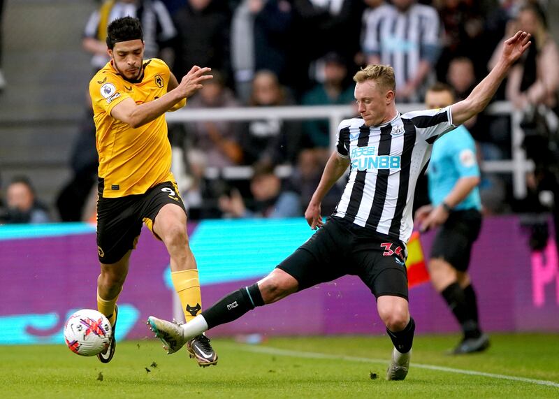 Wolves' Raul Jimenez is challenged by Newcastle midfielder Sean Longstaff. AP