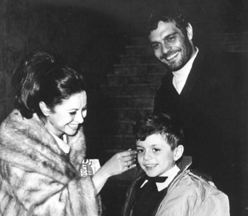 Egyptian actor Omar Sharif is seen with his wife, actress Faten Hamama, and their eight-year-old son, Tarek, as they get together for New Year's Eve celebration in Madrid, Spain, on Dec. 31, 1965. (AP Photo)