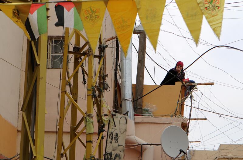 A woman watches from her balcony at the Wavel Palestinian refugee camp (also known as the Jalil camp) in Lebanon's eastern Bekaa Valley, on April 24, 2020, after cases of infection by the novel coronavirus were detected there.  The residents of the Wavel camp were tested after a member of a household, a Palestinian refugee from Syria, was admitted to the state-run Rafic Hariri hospital in the capital Beirut  for demonstrating COVID-19 symptoms. / AFP / -
