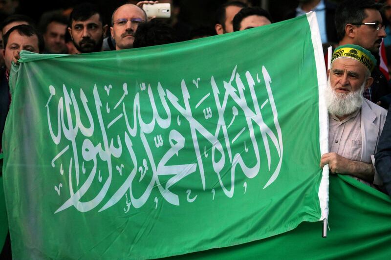 A protester chants slogans as he holds a Hamas flag outside the residence of the Israeli Ambassador in Ankara on May 14, 2018 during a demonstration against US President Donald Trump's decision to move the US embassy from Tel Aviv to Jerusalem. (Photo by ADEM ALTAN / AFP)