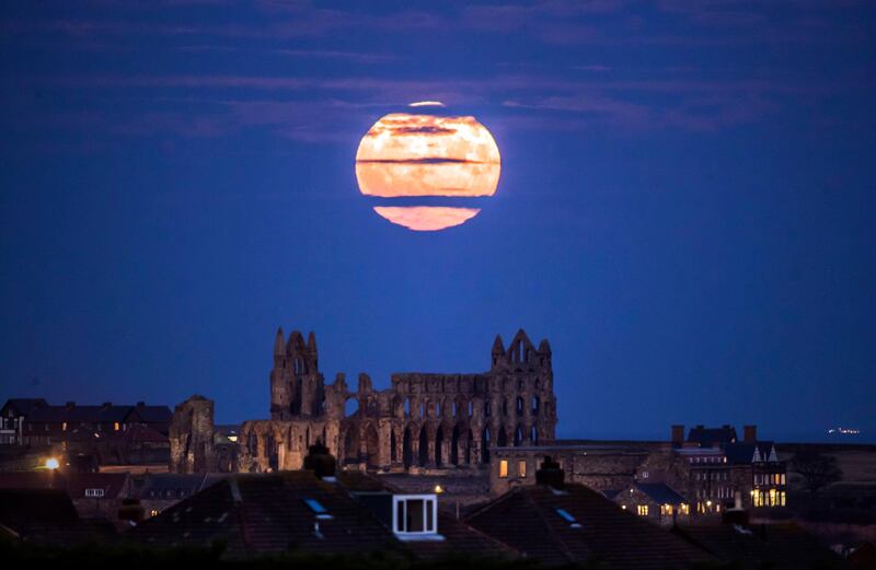 The Supermoon rises above Whitby Abbey in Whitby, north east England. Danny Lawson / PA via AP