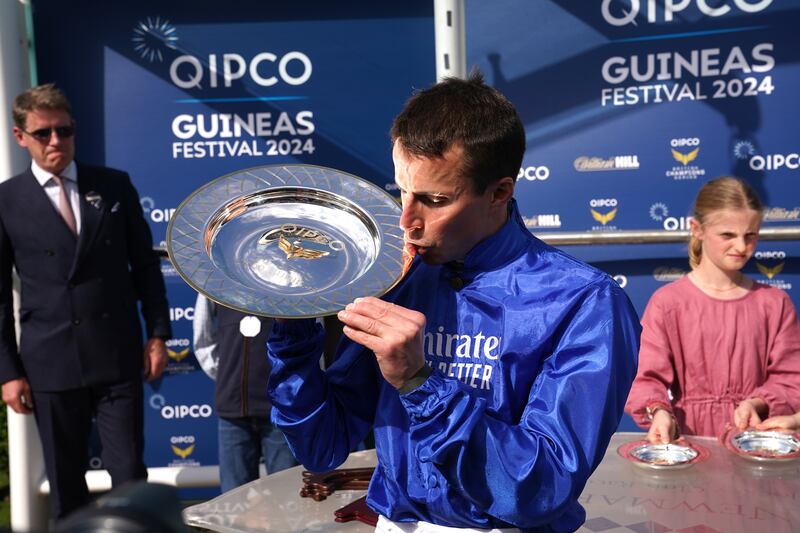Jockey William Buick celebrates with the trophy after winning the 2000 Guineas Stakes for Godolphin. PA 