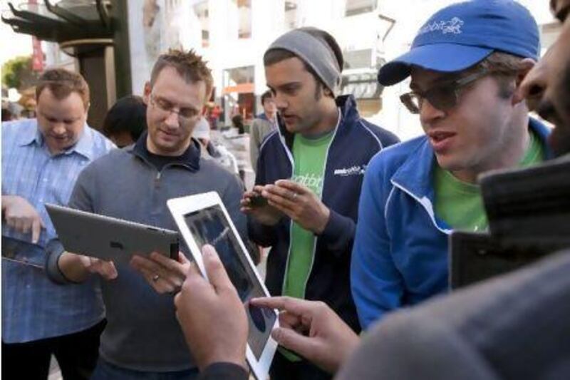 People look at new apps on the Apple iPad. David Paul Morris / Bloomberg News