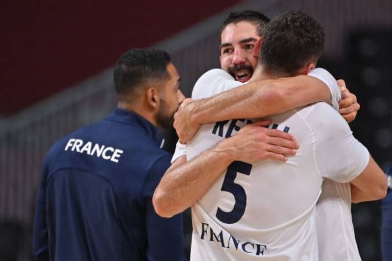 France's centre-back Nikola Karabatic celebrates with a teammate.