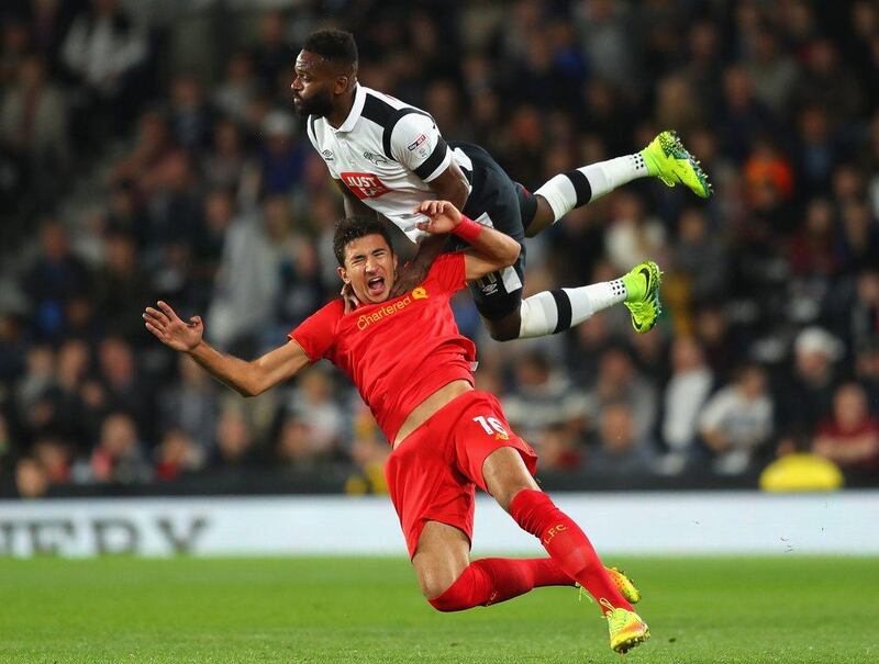 Marko Grujic of Liverpool is challenged by Darren Bent of Derby County during the League Cup third round match. Richard Heathcote / Getty Images