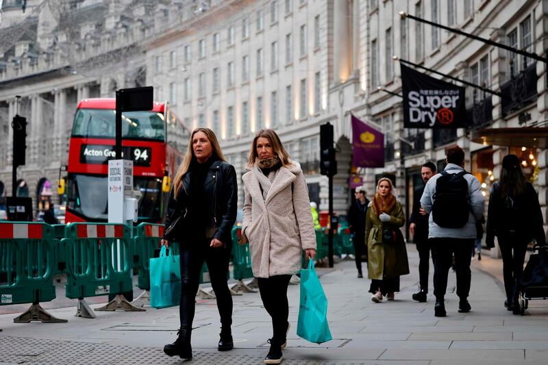 Pedestrians walk through a quiet central London. AFP