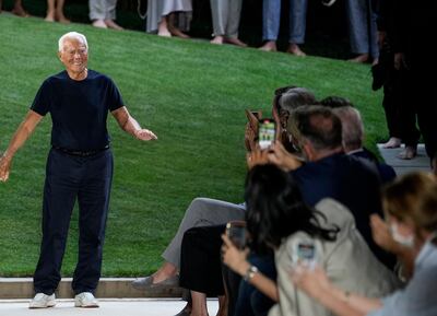 Giorgio Armani accepts applause at the conclusion of his men's Spring Summer 2022 collection, in Milan, Italy, Monday, June 21, 2021. (AP Photo/Luca Bruno)