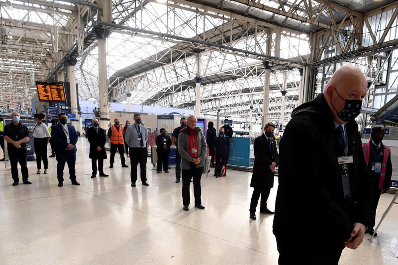 People pause to observe two minute's silence at Waterloo Station in London. Reuters