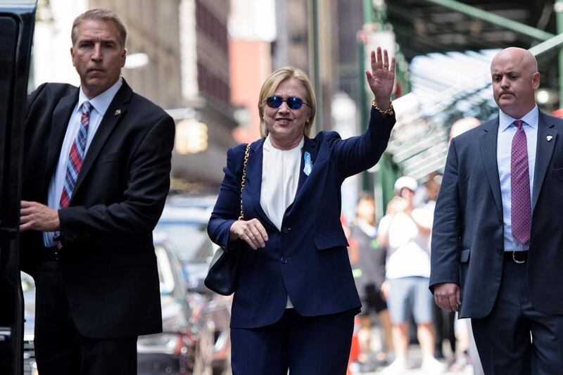 US Democratic presidential nominee Hillary Clinton waves to the press as she leaves her daughter's apartment building after resting on September 11, 2016 in New York. Clinton departed from a remembrance ceremony on the 15th anniversary of the 9/11 attacks after feeling 'overheated', but was later doing 'much better', her campaign said. Brendan Smialowski / AFP

