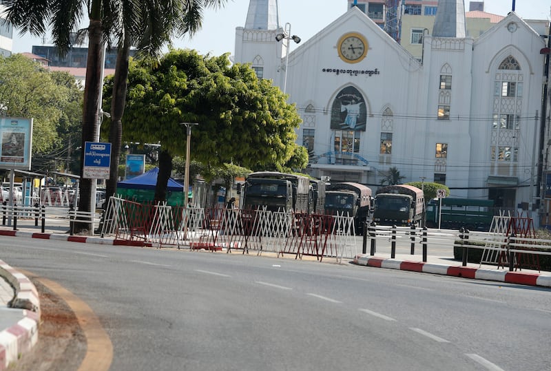 Military vehicles parked in downtown Yangon. On Monday, Ms Suu Kyi was sentenced to four years in prison – subsequently reduced to two years – after being convicted of the first of many charges she faces.  EPA