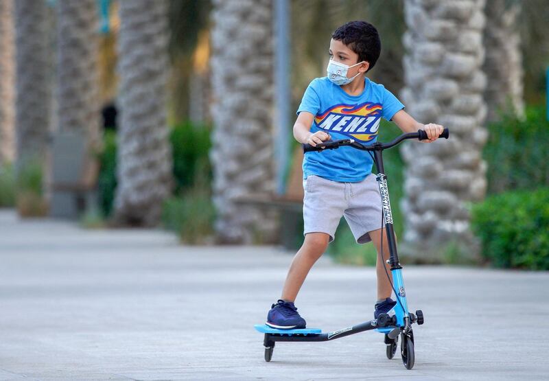 Abu Dhabi, United Arab Emirates, October 26, 2020.  The "new norm" of Covid-19 precautionary measures at Umm Al Emarat Park, Abu Dhabi, on a Monday afternoon.  It is a common sight to see children wearing face masks riding their bikes or scooters at the park.
Victor Besa/The National
Section:  NA
Reporter: