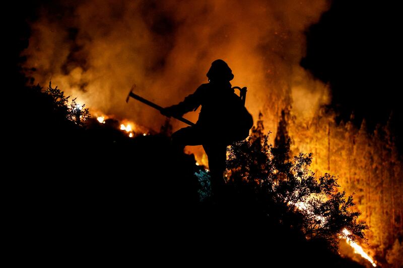 Firefighters tackle a blaze on the Spanish island of Tenerife. Reuters