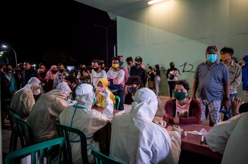 Medical staff taking blood samples from people to be tested for the COVID-19 coronavirus in Surabaya, East Java.  AFP