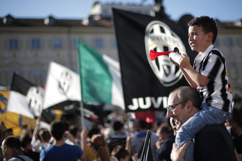 Juventus supporters gather at the Piazza San Carlo in Turin, on Sunday to celebrate their club's Serie A championship. Marco Bertorello / AFP / May 4, 2014