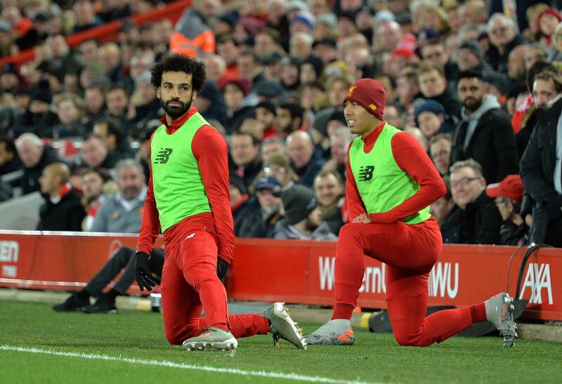 Mohamed Salah and Roberto Firmino warm up during the Premier League match between Liverpool  and Everton. EPA