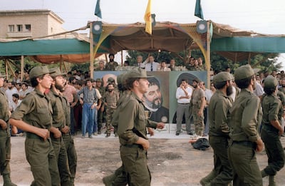 Nabih Berri (C-saluting), reviews militiamen from his Amal movement as they parade, 08 August 1986 in front of Imam Moussa Al Sadr portrait in the southern suburb of west Beirut. Berri, led the Amal movement, the first political organization of Lebanon's Shi'ite Moslems, during the fierce fighting of Lebanon's civil war. Berri was a key player in the negotiated release of the hostages following the hijacking of TWA Flight 847 in Beirut. He was elected Speaker of the Lebanese parliament 20 November 1992.  AFP PHOTO ASSAD JRADI / AFP PHOTO / ASSAD JRADI