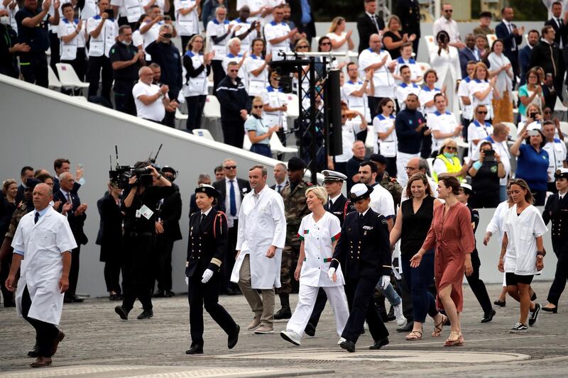 Healthcare workers are applauded at the Bastille Day parade. AP