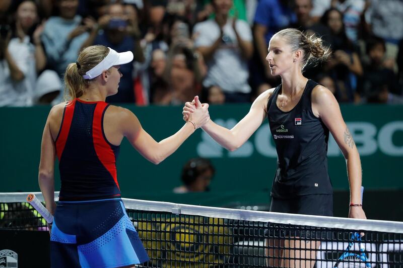 Caroline Wozniacki of Denmark, left, greets Karolina Pliskova of the Czech RepublicÂ after their match at the WTA tennis finals in Singapore, Sunday, Oct. 21, 2018. (AP Photo/Vincent Thian)