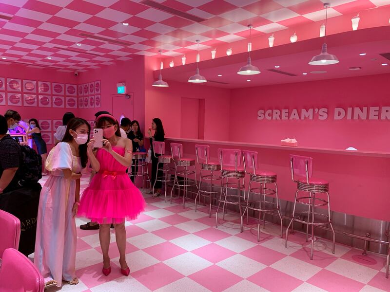 Visitors take photos in the 'Scream's Diner' at the Museum of Ice Cream in Singapore. Reuters