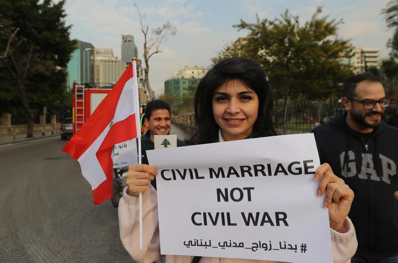 epa07391014 Lebanese activists from civil society carry placards during a protest demanding the civil marriage law, in front the Interior Ministry in Beirut, Lebanon 23 February 2019. Recently, there has been an old debate about allowing civil marriage in Lebanon, coinciding with the announcement by the new interior minister Raya Al-Hassan of her support. Where the Muslims, Christians clerics are objected the civil marriage law in Lebanon. The Lebanese state recognizes any civil marriage outside its territory, but has not yet approved a mechanism allowing its citizens to marry on its territory. This arrangement does not convince many activists who advocate civil marriage and refuse to be forced, as now, to obey the laws of their sects. In the 1950s, this idea was first proposed, and since then it has been confronted with the same problem - the rejection of sectarian and religious authorities. Till now nobody of Lebanese officials to dared to raise the issue of the issue of civil marriage in the House of Representatives without the consent of the clerics. . Since most of the politicians in Lebanon are at the disposal of the clergy and do not anger them, because the cleric is able to move the street more than the political.  EPA/NABIL MOUNZER